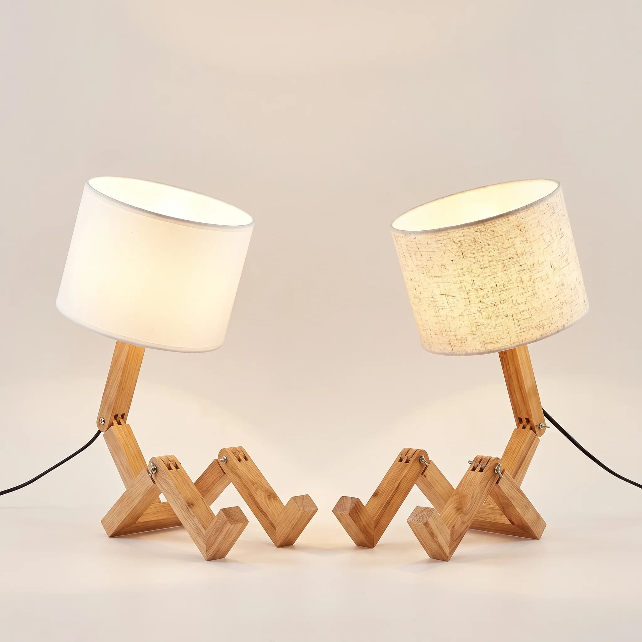 Otto — Jointed Wood Desk Lamp, lit in a dark room